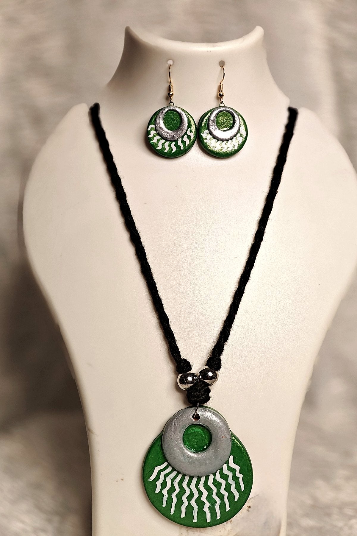 Alternate angle of layered terracotta sun disc medallion pendant in emerald green and silver - Bong Trendz