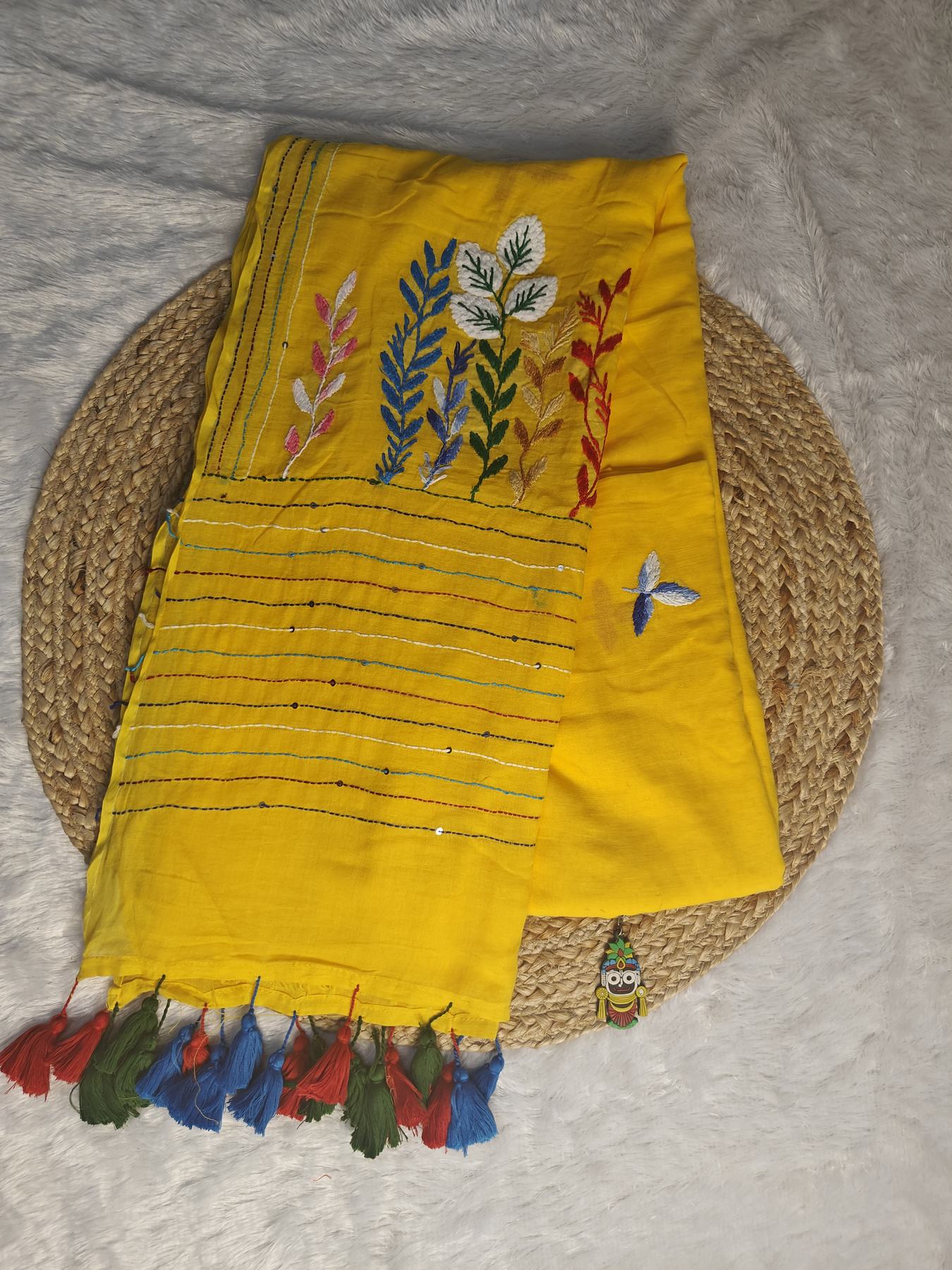 Yellow Belpotra pure mul cotton saree flatlay with bullion stitch bael leaf embroidery, sequin-dotted pallu and multicolour tassels