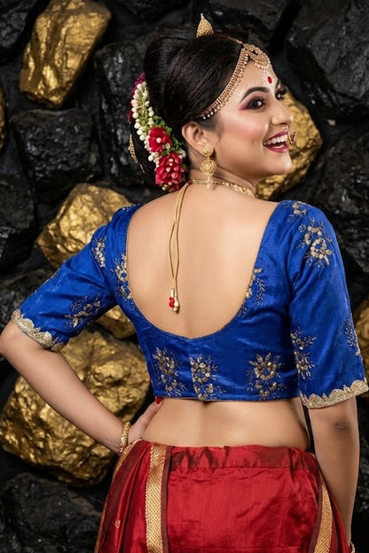 Deep scoop back design of heavy blue festive blouse with hook closure