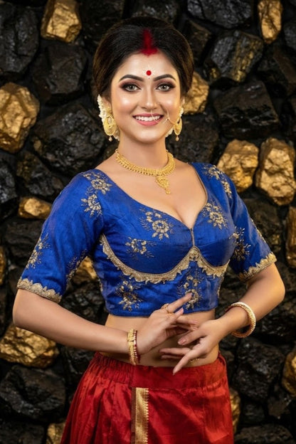 Front view of royal blue Sabyasachi style silk blouse with intricate golden zari embroidery and sweetheart neckline.