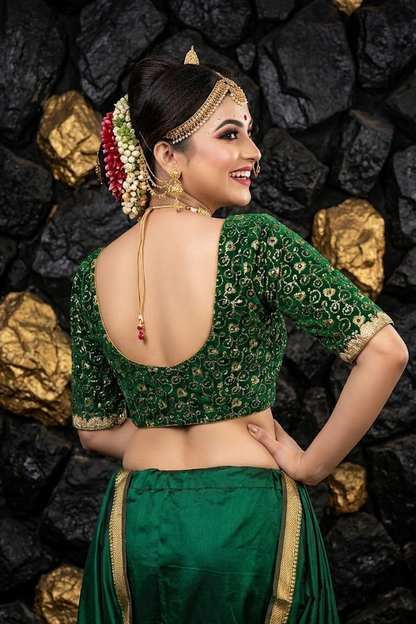 Deep scoop back design of green bridal blouse with hook closure.