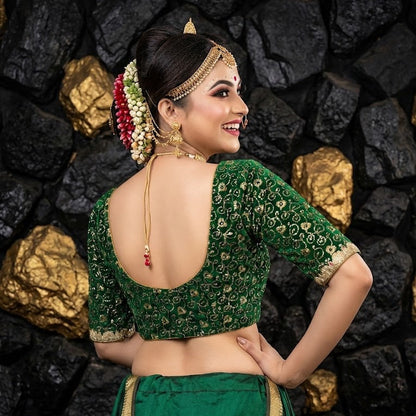 Deep scoop back design of green bridal blouse with hook closure.