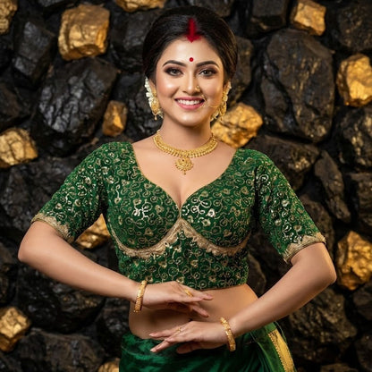 Front view of green Sabyasachi style silk blouse with heavy golden zari embroidery and sweetheart neckline.