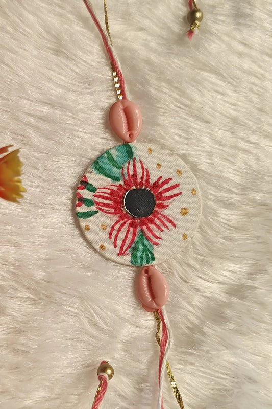 Hand-painted red floral fabric rakhi with pink cowrie shells – Bengal Raksha Bandhan thread by Bong Trendz