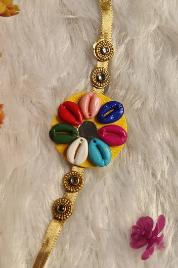 Multicolour cowrie shell fabric rakhi on a golden ribbon – handmade Raksha Bandhan thread by Bong Trendz