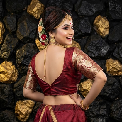 Sweetheart back design of red festive blouse with hook closure.