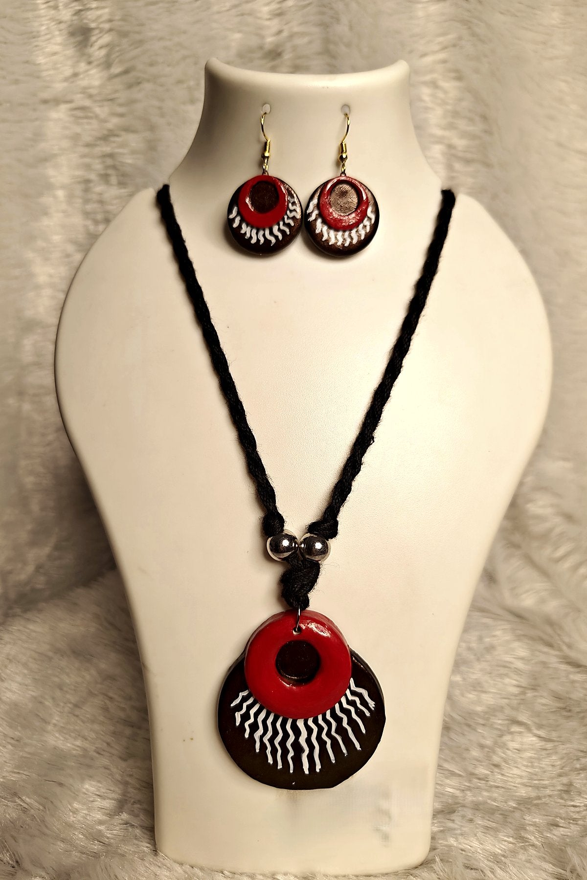 Alternate angle of layered terracotta sun disc medallion pendant in crimson and espresso brown - Bong Trendz