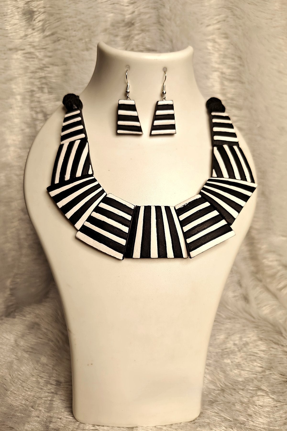 Close-up of hand-painted black-white chevron stripe terracotta collar necklace - Bong Trendz