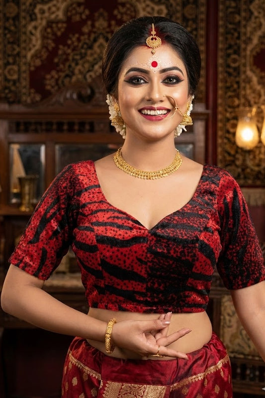 Front view of red velvet blouse with black animal print stripes and deep sweetheart neckline.