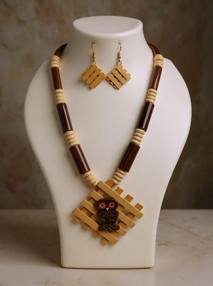Cream bamboo lattice pendant with carved owl centre on brown and cream bead necklace with matching lattice earrings on a white bust