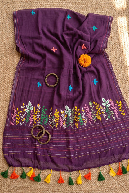 Purple Belpotra mul cotton saree styled flatlay with marigold flower and bangles