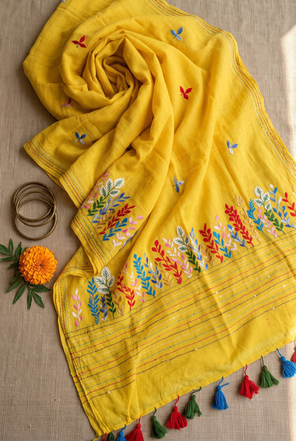 Yellow Belpotra mul cotton saree rolled and styled with marigold flower and bangles