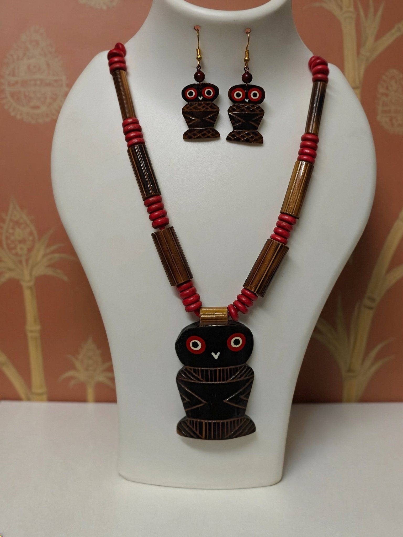 Hand-painted black wooden owl pendant with red eyes on bamboo tube necklace with red beads and matching owl earrings