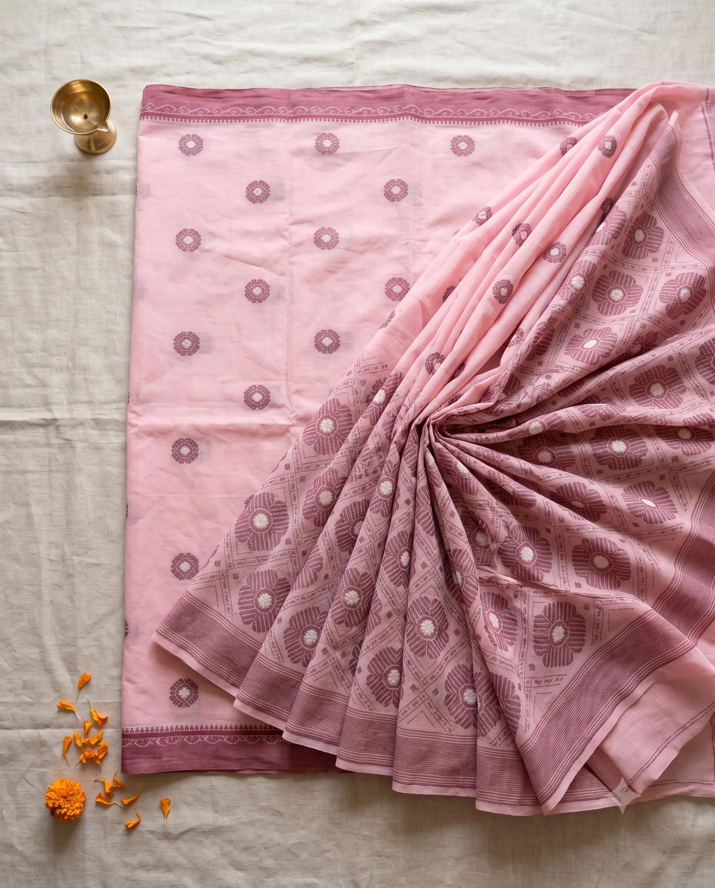 Close-up texture of hand-thrown Jamdani buti weave on pure cotton, Santipur-Fulia handloom mark certified