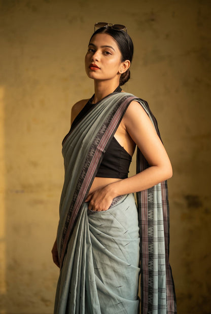Konika grey Shantipur handloom cotton saree side profile with sunglasses, maroon striped border