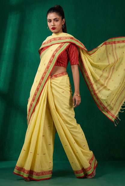 Konika yellow Shantipur GI tag handloom cotton saree with flowing pallu, red and green woven border, butta motifs
