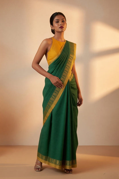 Patrangi green Shantipur handloom check cotton saree styled standing pose, gold border detail
