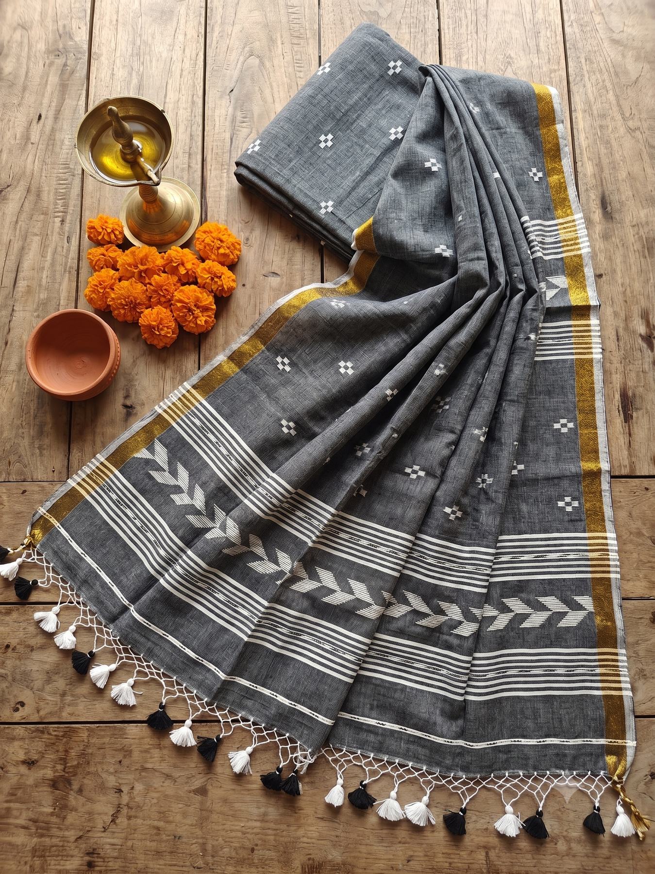 Tirlata grey cotton saree flat lay with golden border and arrow buti pallu