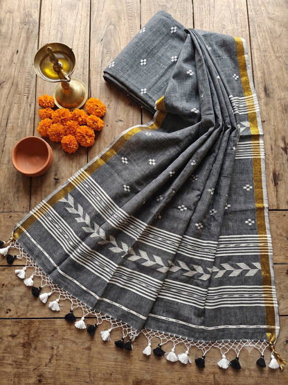 Tirlata grey cotton saree flat lay with golden border and arrow buti pallu