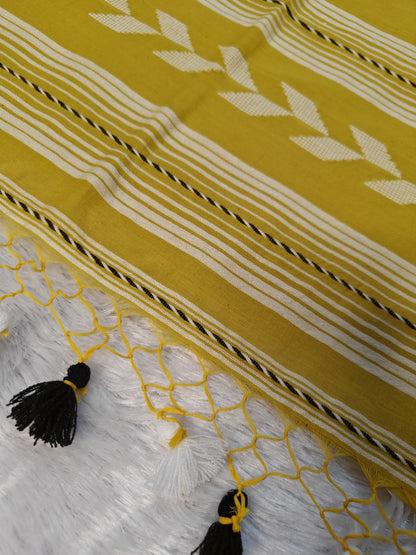 Close-up of the mustard Tirlata saree's pallu tassels and arrow buti border