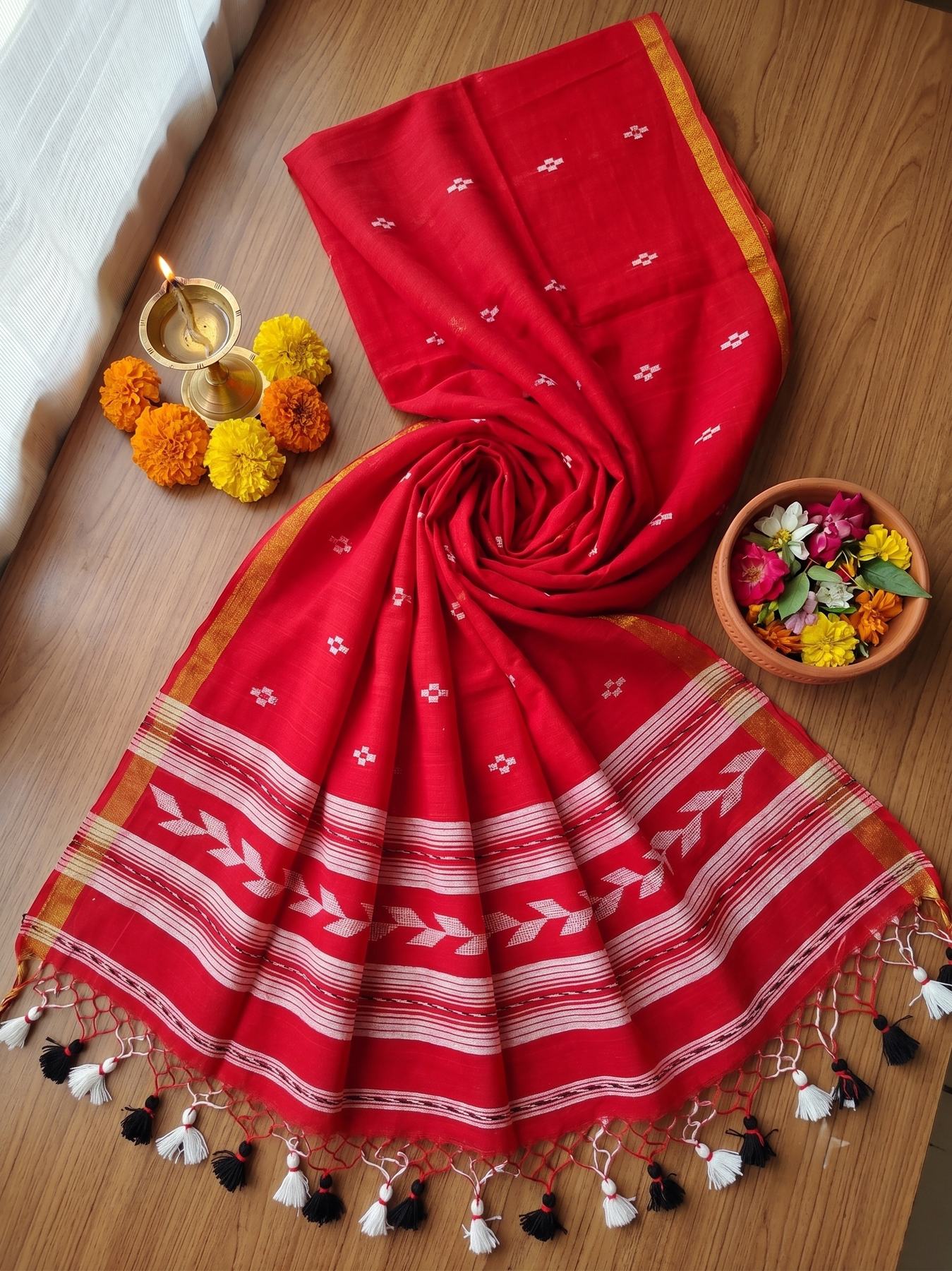 Tirlata red cotton saree flat lay showing the all-over flower butti and arrow buti border