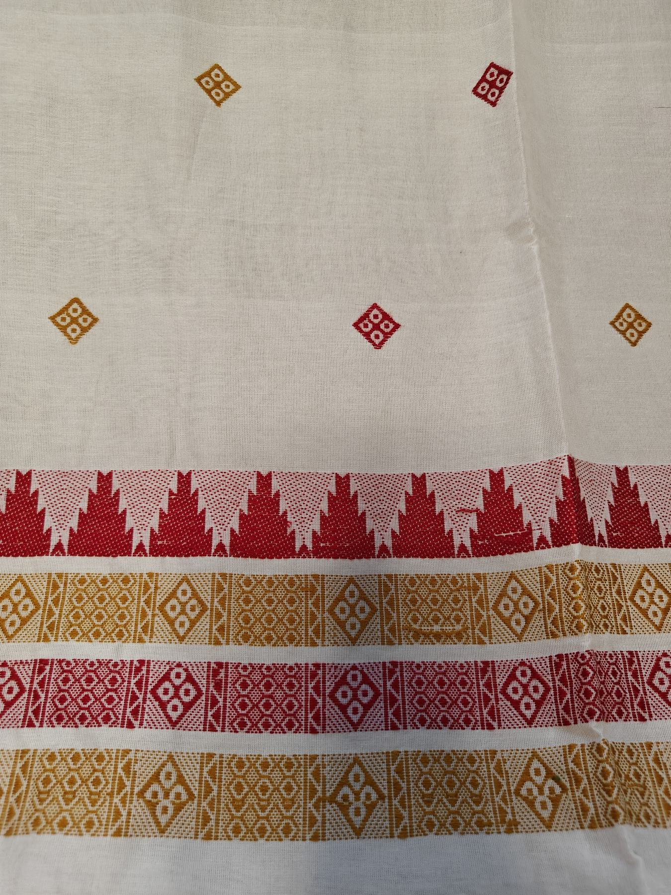 Close-up of red and mustard-gold buti motifs and striped pallu border bands on the Ushoshi off-white handwoven cotton saree